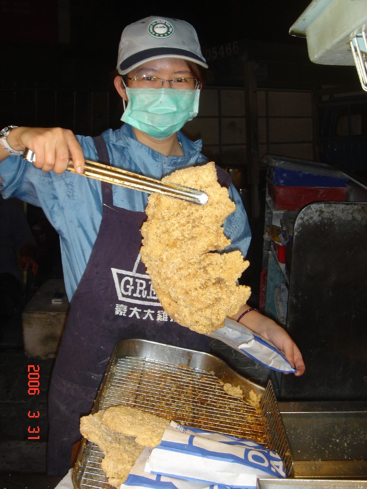 A giant fried chicken cutlet (雞排) freshly fried at a Taiwan night market stall