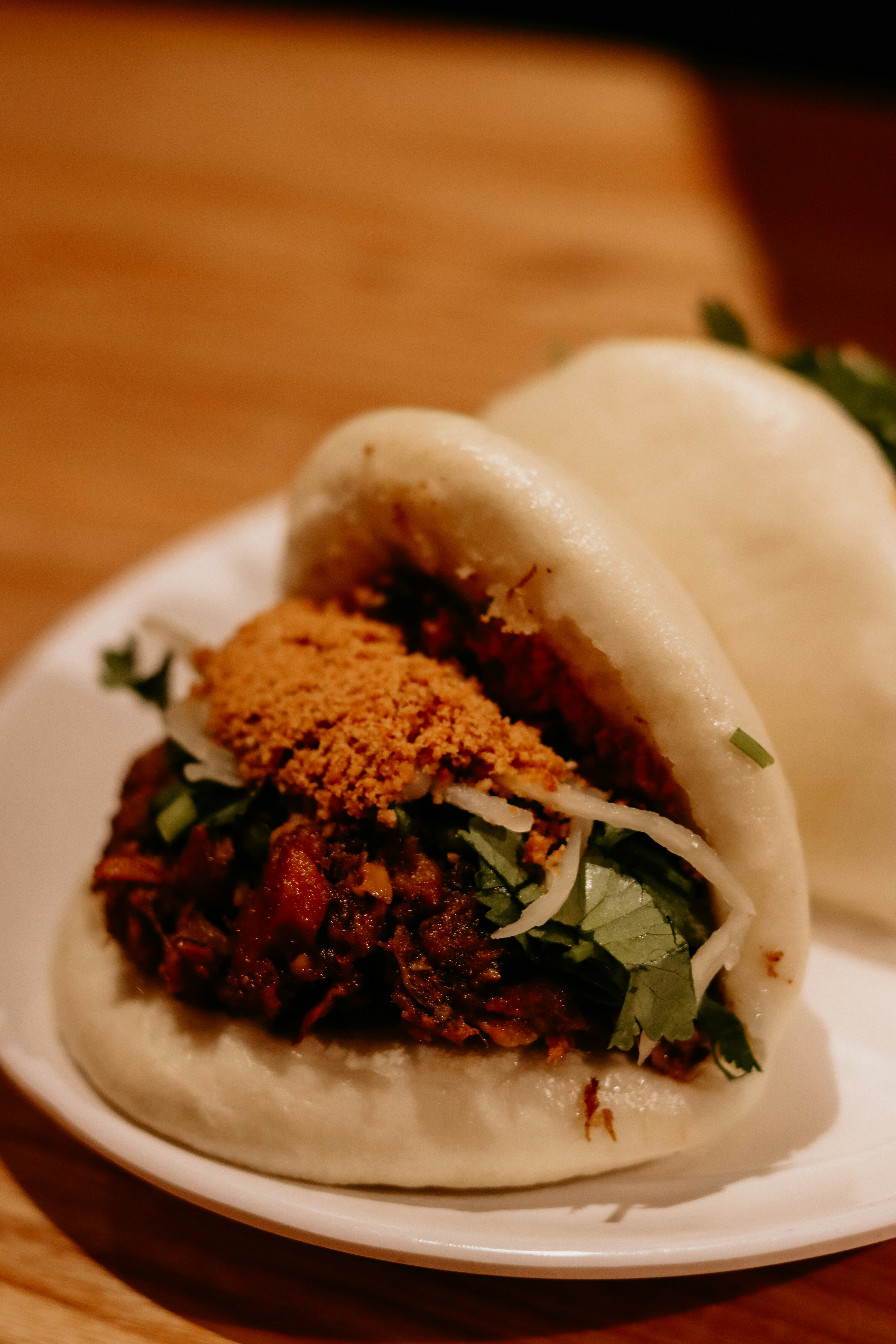 Gua bao with braised pork filling, peanut sugar, and cilantro