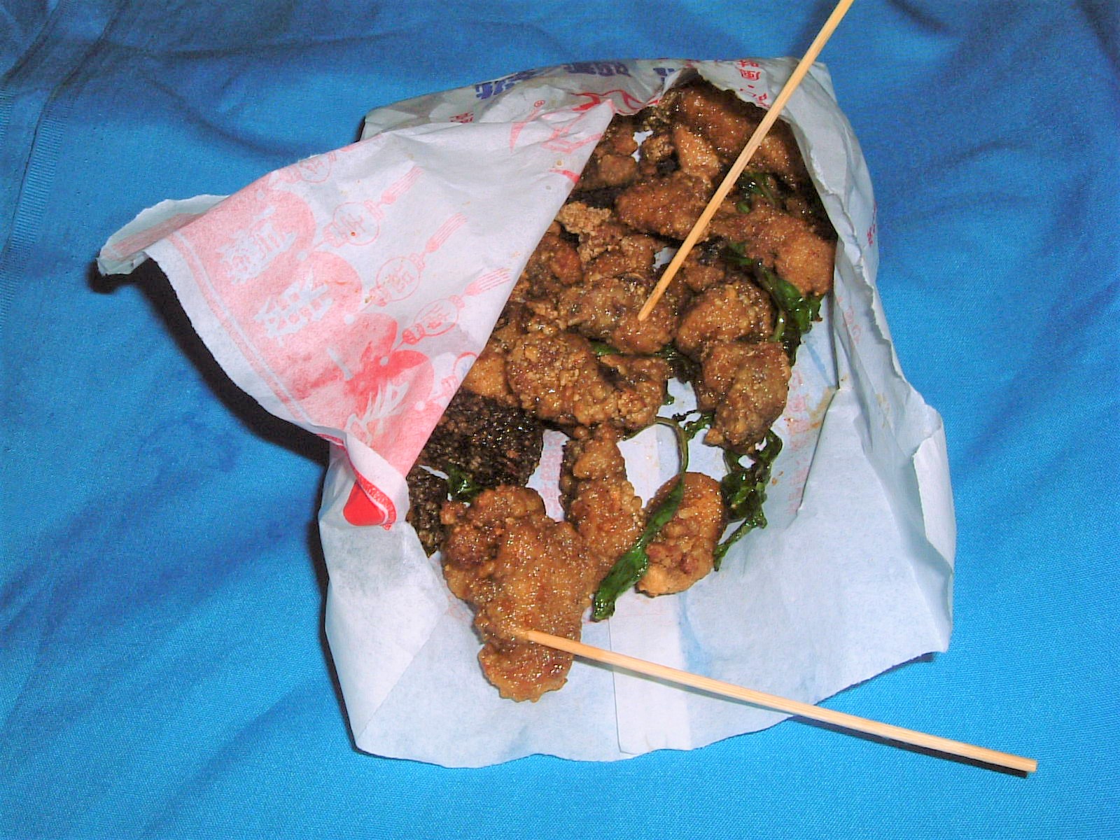 A bag of 鹹酥雞 Taiwanese fried chicken with fried basil leaves